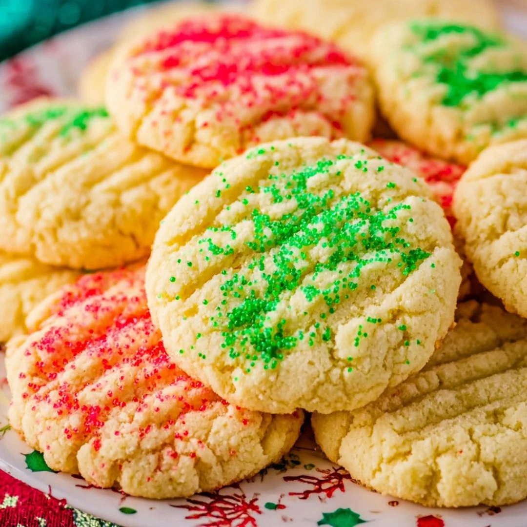 Delicious Christmas sugar cookies decorated with festive icing and sprinkles.