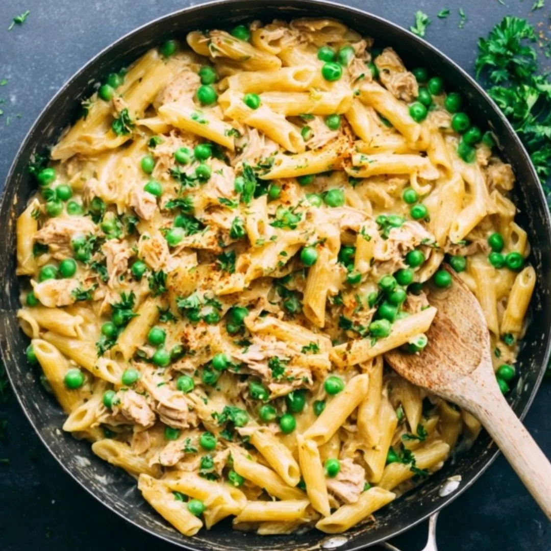 Delicious bowl of tuna pasta topped with fresh herbs and vegetables