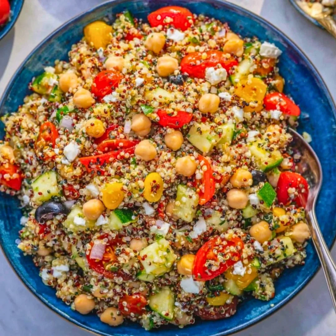 Healthy Greek quinoa salad with chickpeas and lemon dressing on a plate.