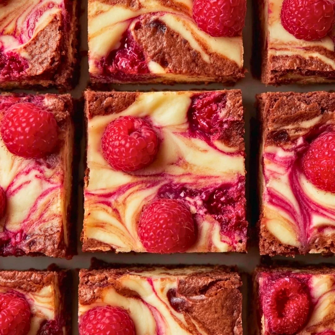 Delicious Raspberry Cheesecake Brownies topped with fresh raspberries