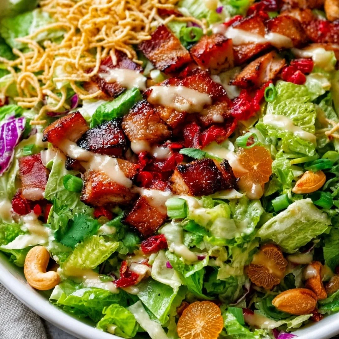 Bowl of healthy Asian Chicken Salad with colorful vegetables and sesame dressing