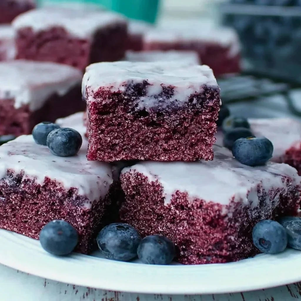 A bright, fizzy blue beverage with granulated salt crystals and a clear jar on a granite surface.