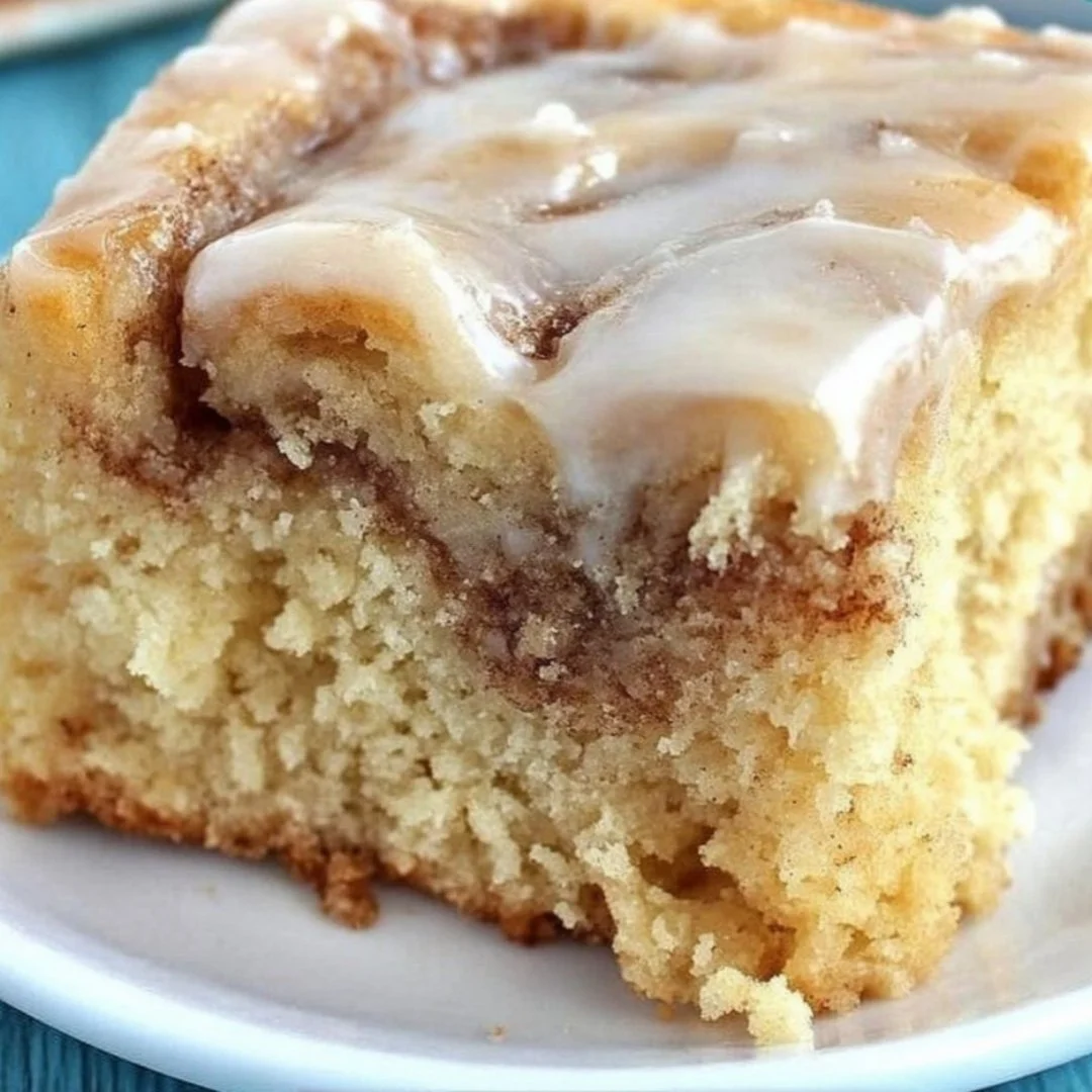 Delicious homemade cinnamon roll cake fresh from the oven with icing on top.